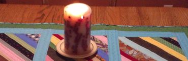 Quilted table runner with candle on wood table